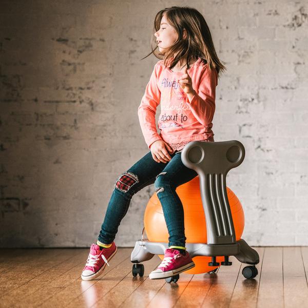 Sitting on the Orange and Grey Kids Classic Balance Ball Chair